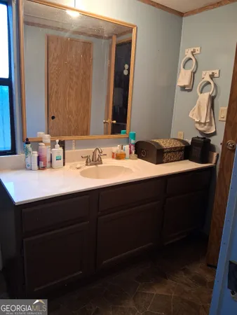 a bathroom with a sink and a mirror