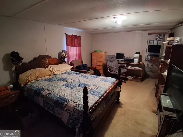a bed room with a bed and a gym machine