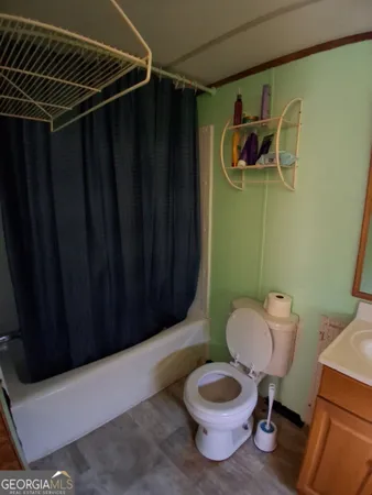 a bathroom with a toilet a sink and shower