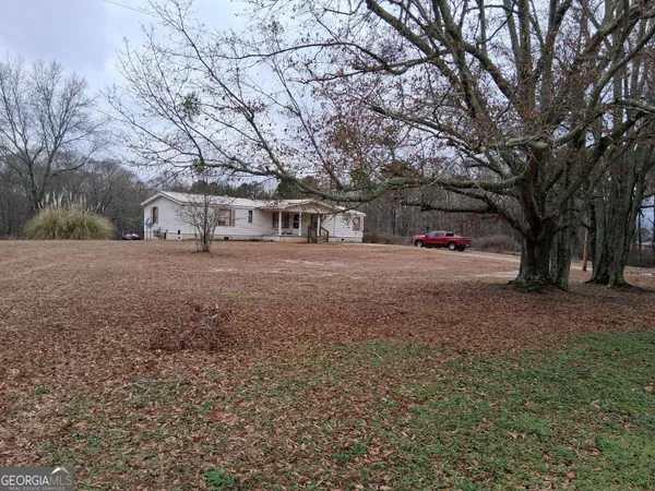 a view of large trees with a house