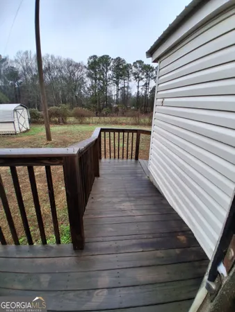 a view of balcony with wooden floor and fence