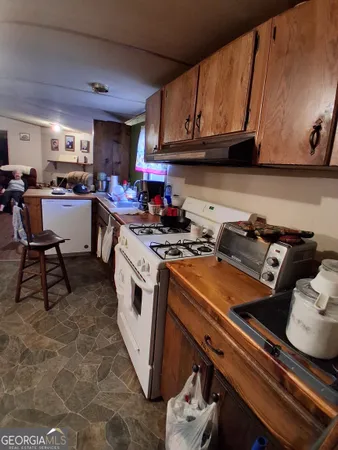a kitchen with a sink appliances and cabinets