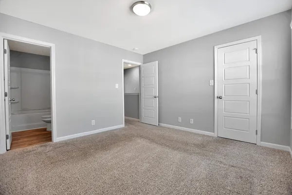 an empty room with closet area
