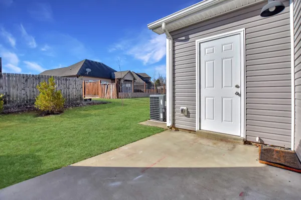 a view of a house with a yard and garage