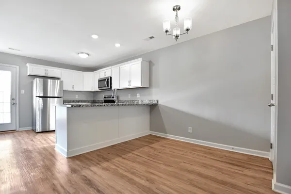 a view of a kitchen with wooden floor