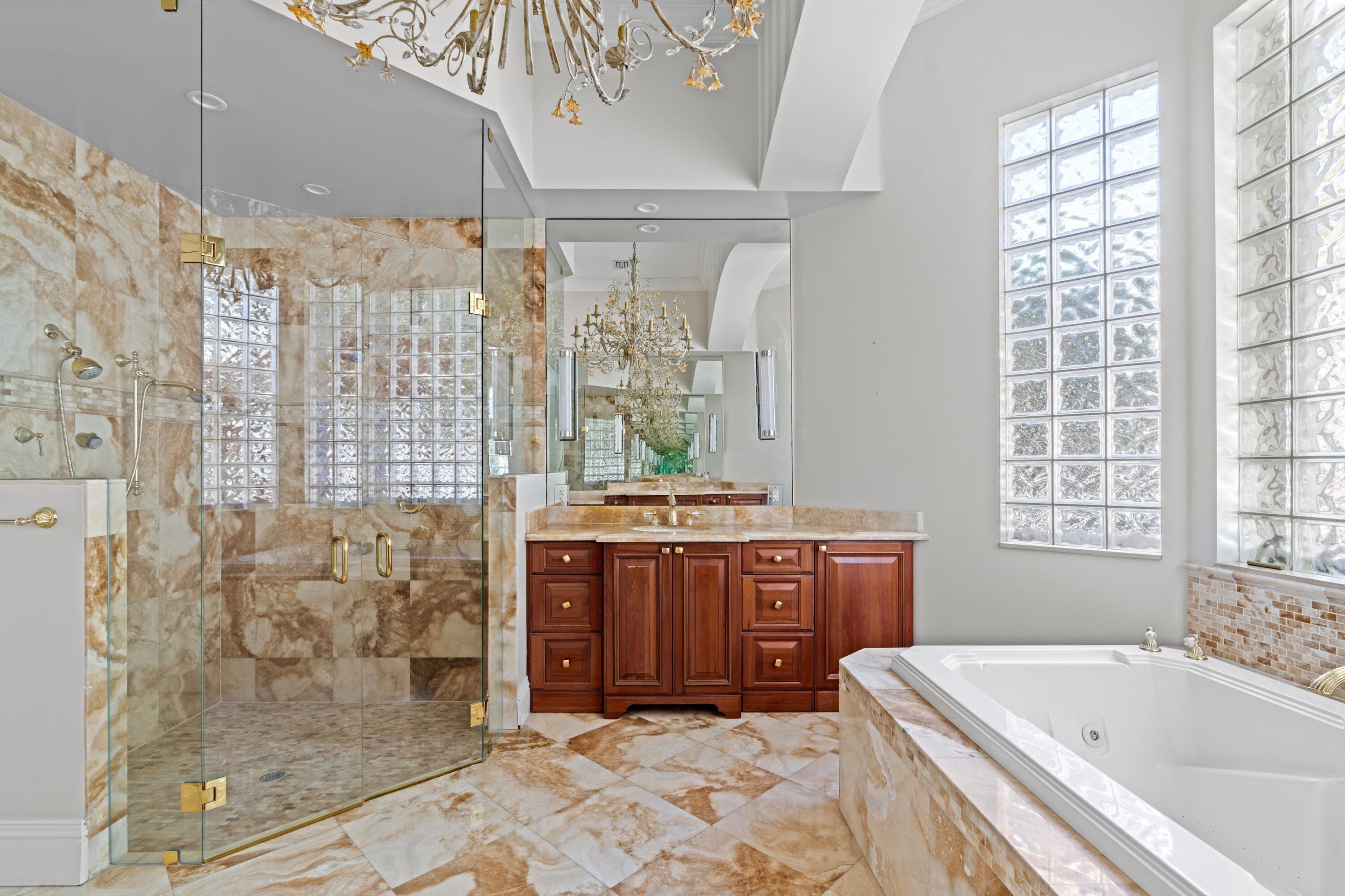 3054 Northwest 60th Street Boca Raton, FL 33496 - Photo 12 of 48 a spacious bathroom with a tub sink and mirror