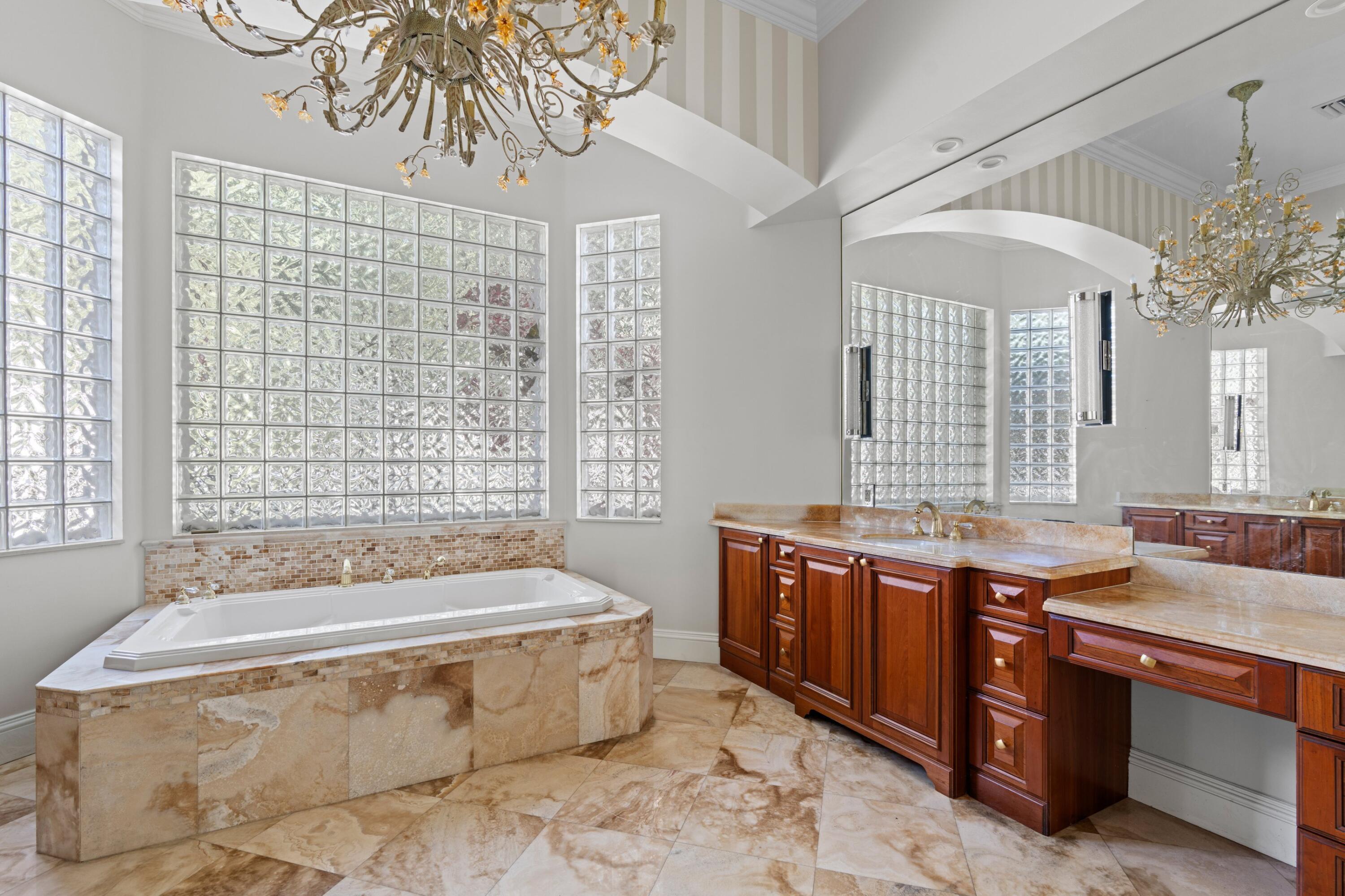 3054 Northwest 60th Street Boca Raton, FL 33496 - Photo 13 of 48 a spacious bathroom with a tub sink and mirror