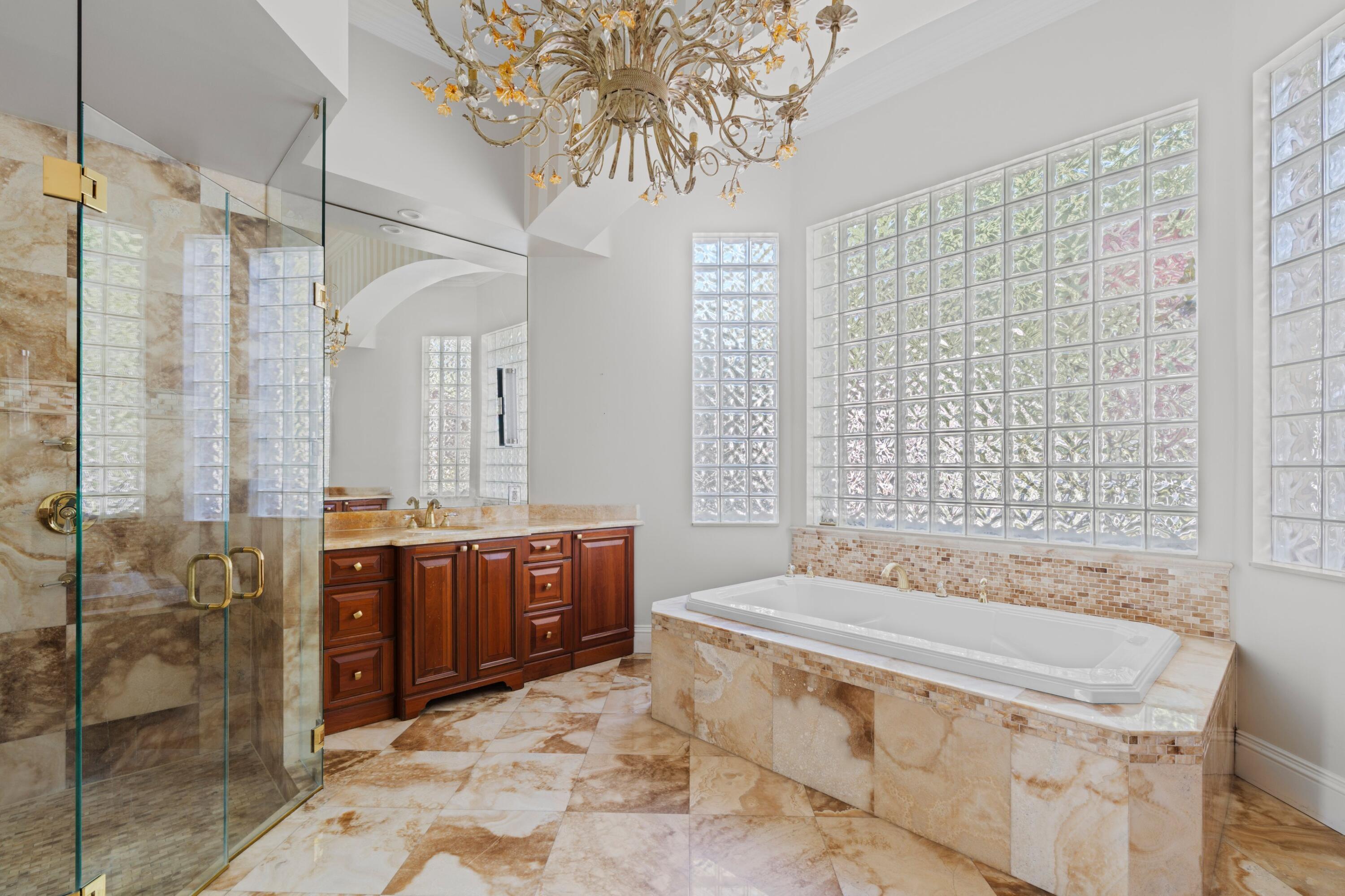 3054 Northwest 60th Street Boca Raton, FL 33496 - Photo 14 of 48 a spacious bathroom with a granite countertop sink a toilet and shower