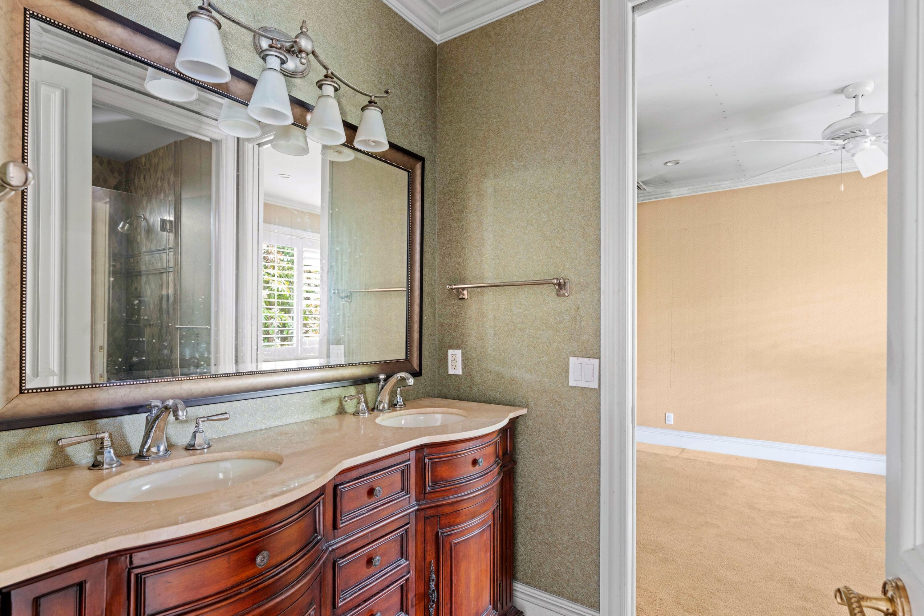 3054 Northwest 60th Street Boca Raton, FL 33496 - Photo 16 of 48 a bathroom with a granite countertop sink and a mirror