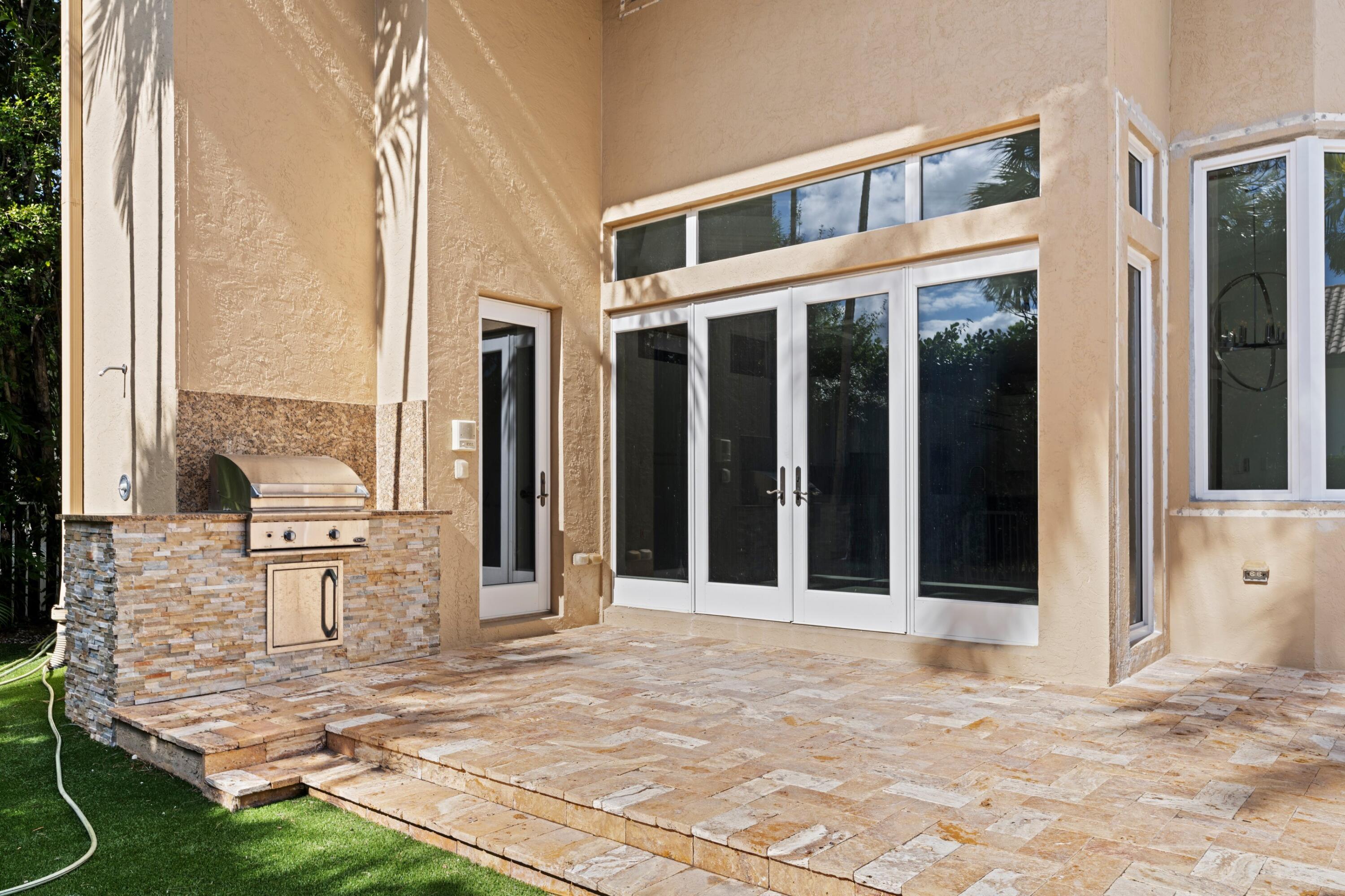 3054 Northwest 60th Street Boca Raton, FL 33496 - Photo 19 of 48 a view of a balcony with table and chairs