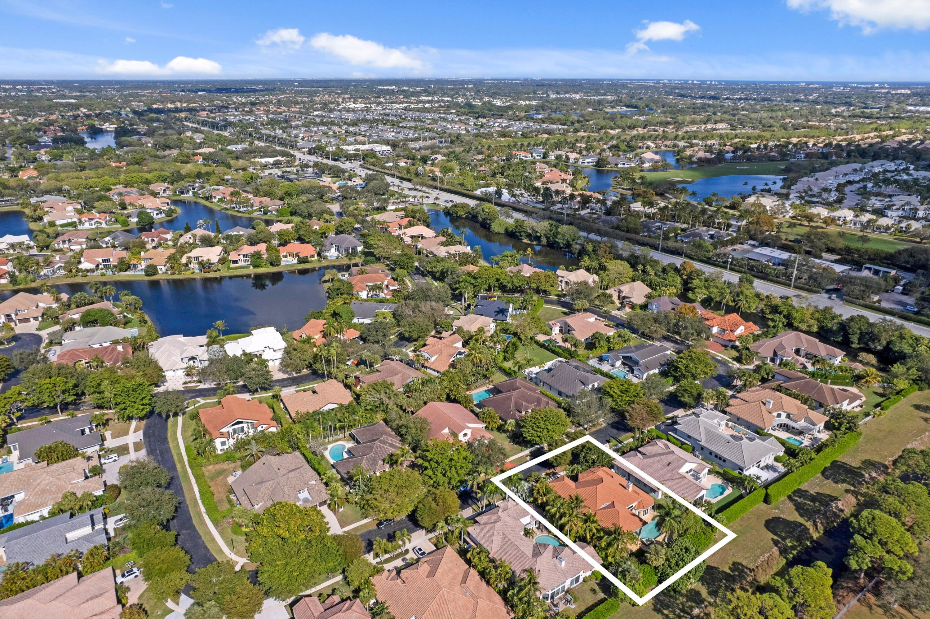 3054 Northwest 60th Street Boca Raton, FL 33496 - Photo 21 of 48 an aerial view of a city with lots of residential buildings ocean and mountain view in back