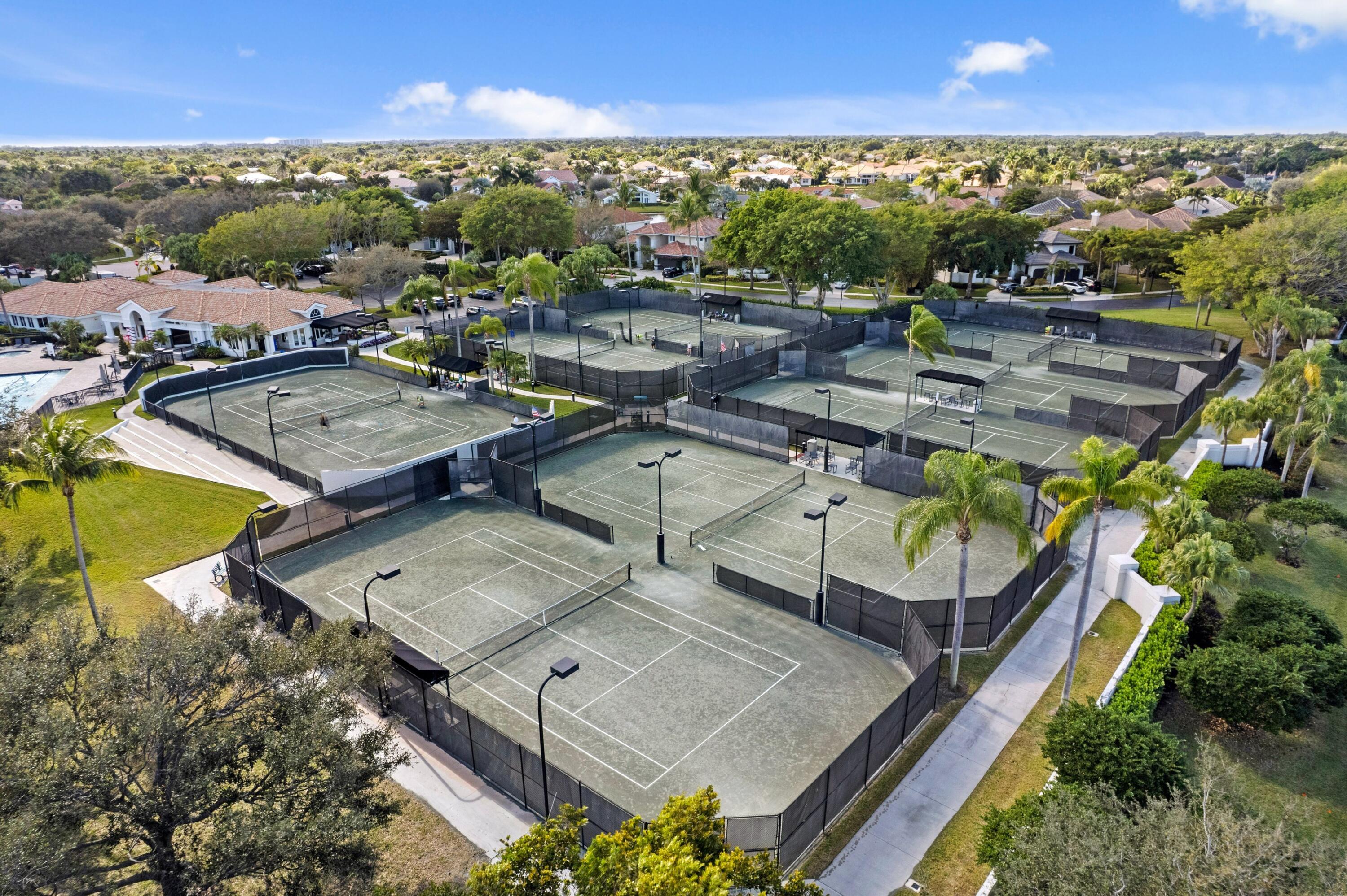 3054 Northwest 60th Street Boca Raton, FL 33496 - Photo 25 of 48 an aerial view of a house with a swimming pool lake and mountain view