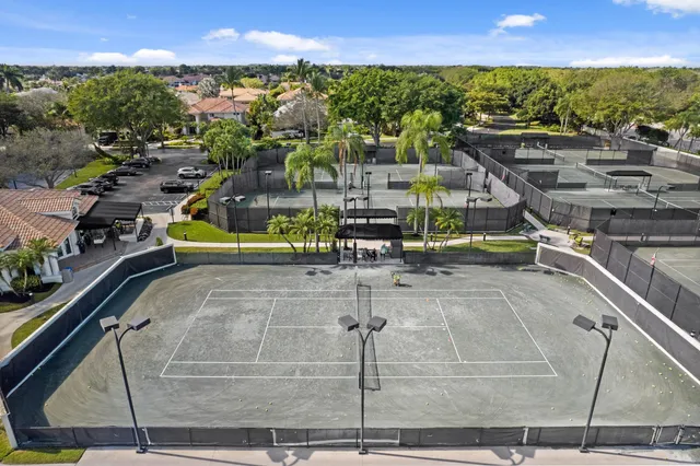 a view of a house with pool and chairs