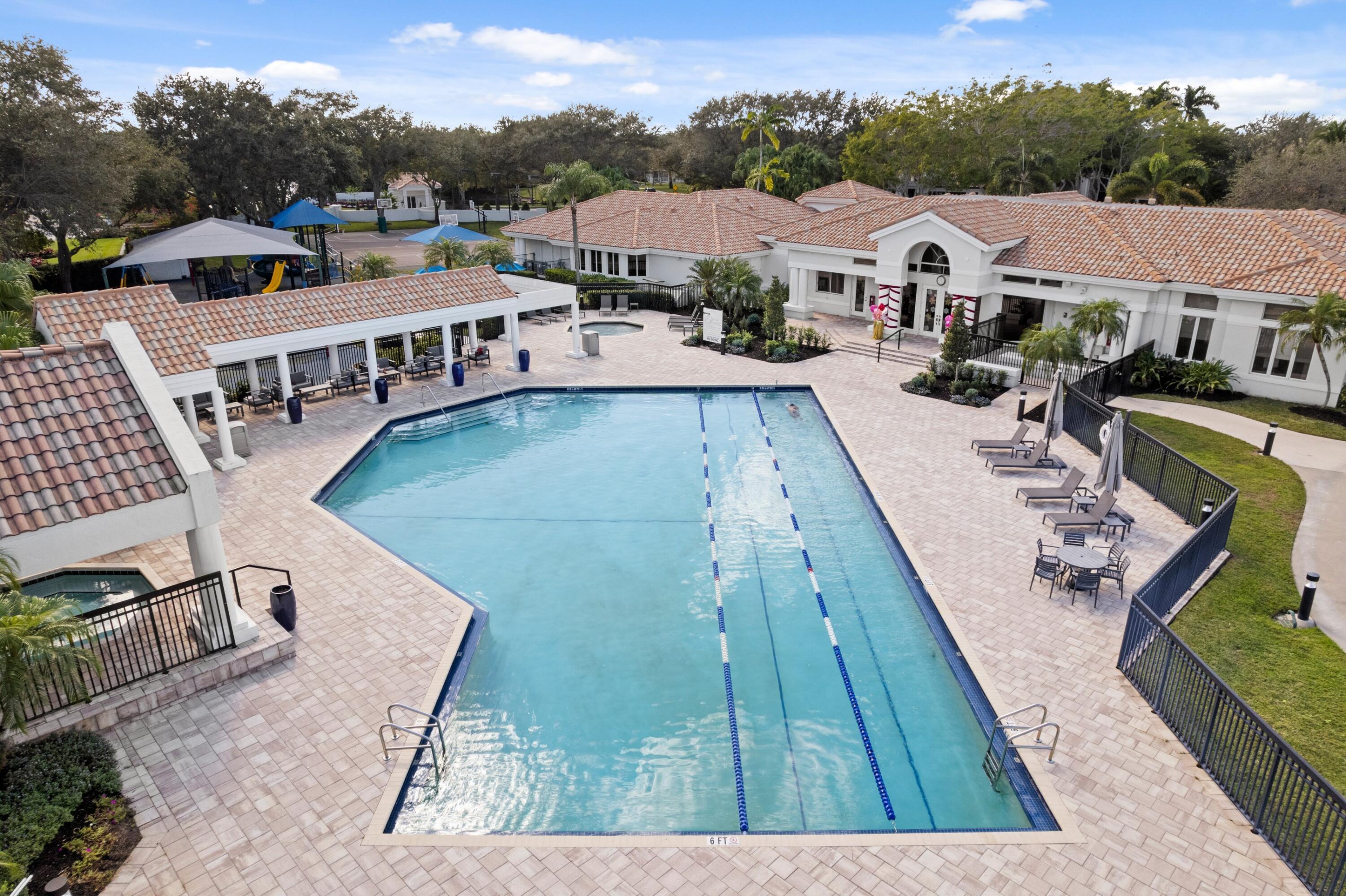 3054 Northwest 60th Street Boca Raton, FL 33496 - Photo 28 of 48 a view of a house with pool and chairs