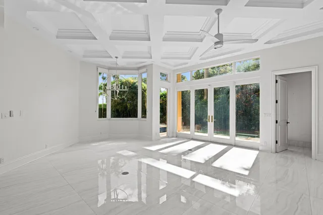 a kitchen with stainless steel appliances granite countertop a sink a microwave a stove and white cabinets with wooden floor