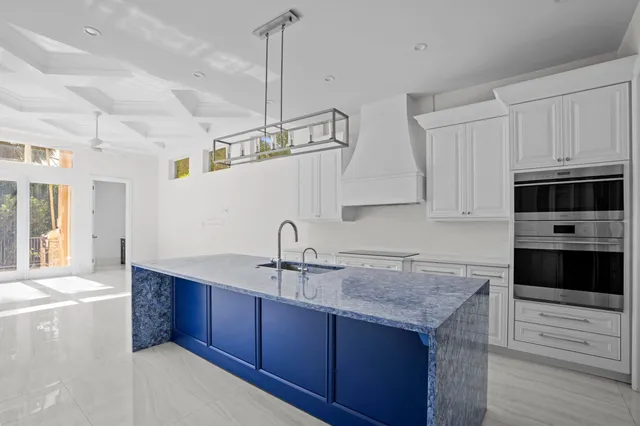 a kitchen with cabinets a sink and appliances