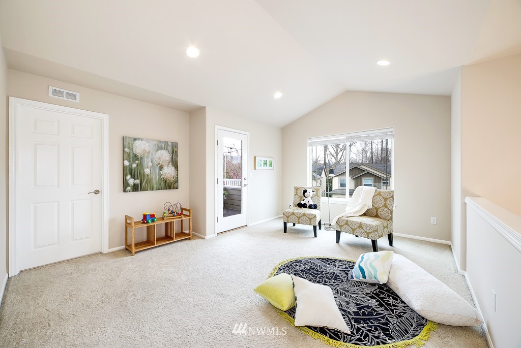 23606 17th Avenue West Bothell, WA 98021 - Photo 15 of 28 a spacious bedroom with a bed a couch and a window