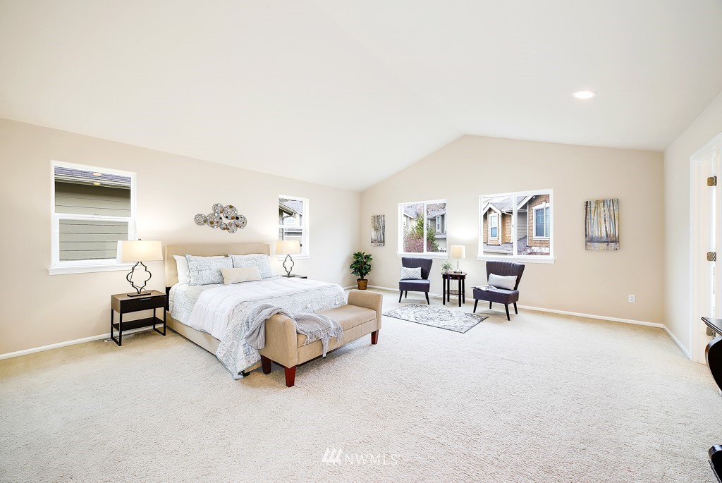 23606 17th Avenue West Bothell, WA 98021 - Photo 17 of 28 a spacious bedroom with a bed a table and a large window