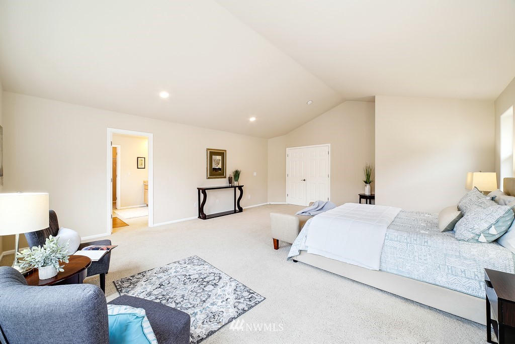 23606 17th Avenue West Bothell, WA 98021 - Photo 18 of 28 a spacious bedroom with a bed a couch and dresser