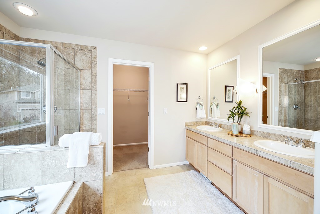 23606 17th Avenue West Bothell, WA 98021 - Photo 19 of 28 a spacious bathroom with a granite countertop sink a mirror and a shower