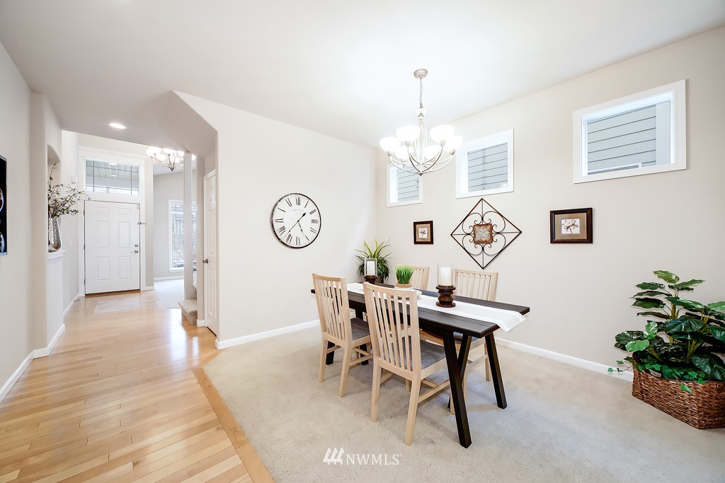 23606 17th Avenue West Bothell, WA 98021 - Photo 6 of 28 a view of a dining room with furniture and a chandelier