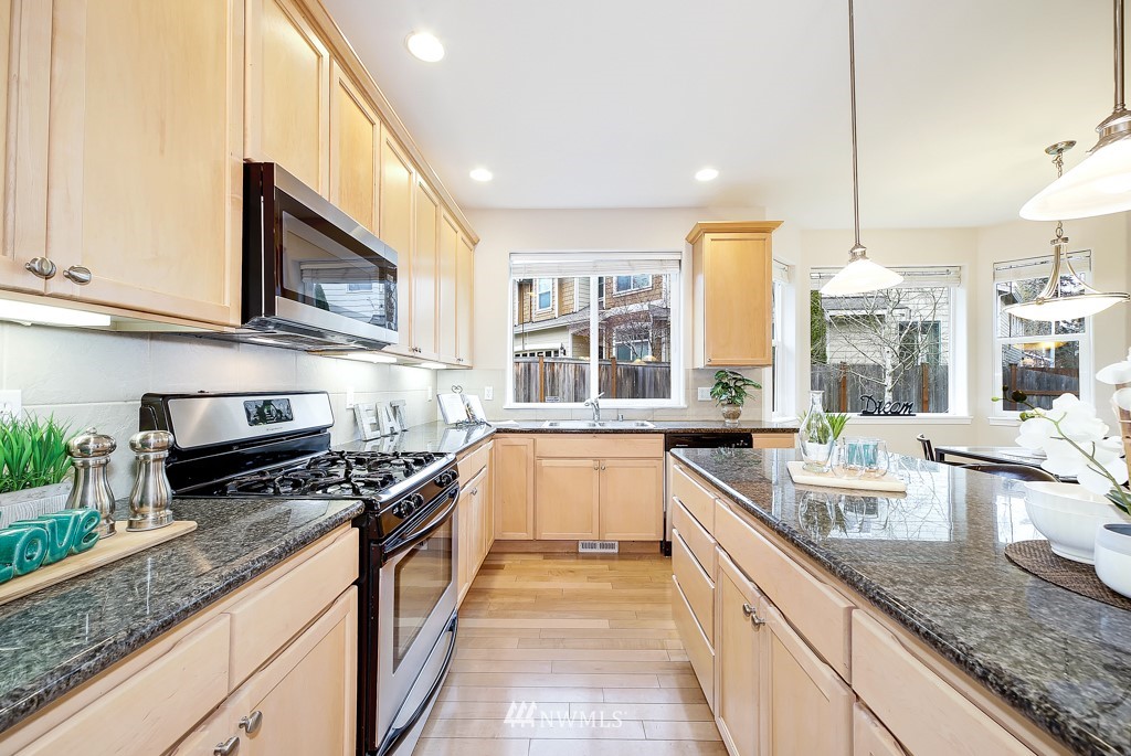 23606 17th Avenue West Bothell, WA 98021 - Photo 8 of 28 a kitchen with stainless steel appliances granite countertop a sink and stove top oven