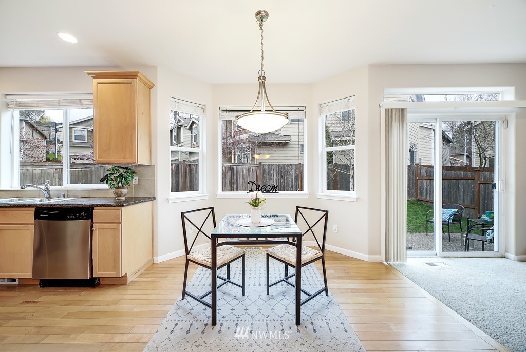 23606 17th Avenue West Bothell, WA 98021 - Photo 10 of 28 a dining room with furniture window wooden floor