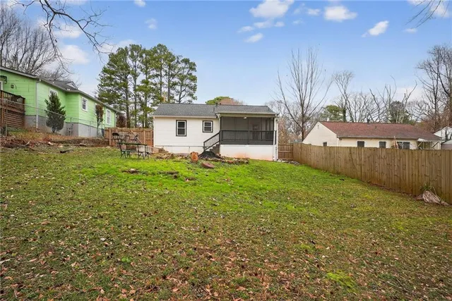 a view of a house with a backyard