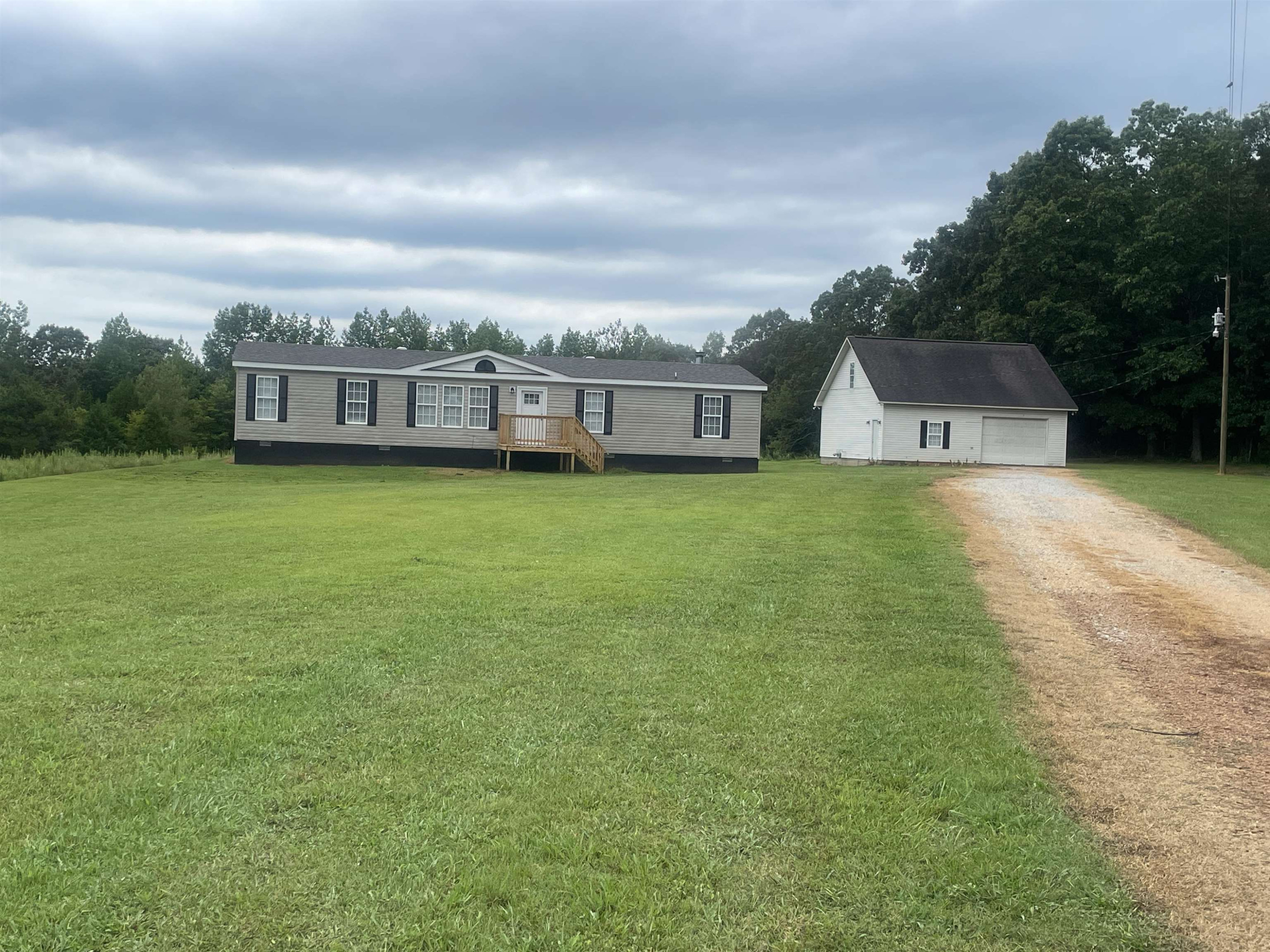 1175 Lott Road Henderson, TN 38340 - Photo 22 of 22 an aerial view of residential house with yard and trees in the background