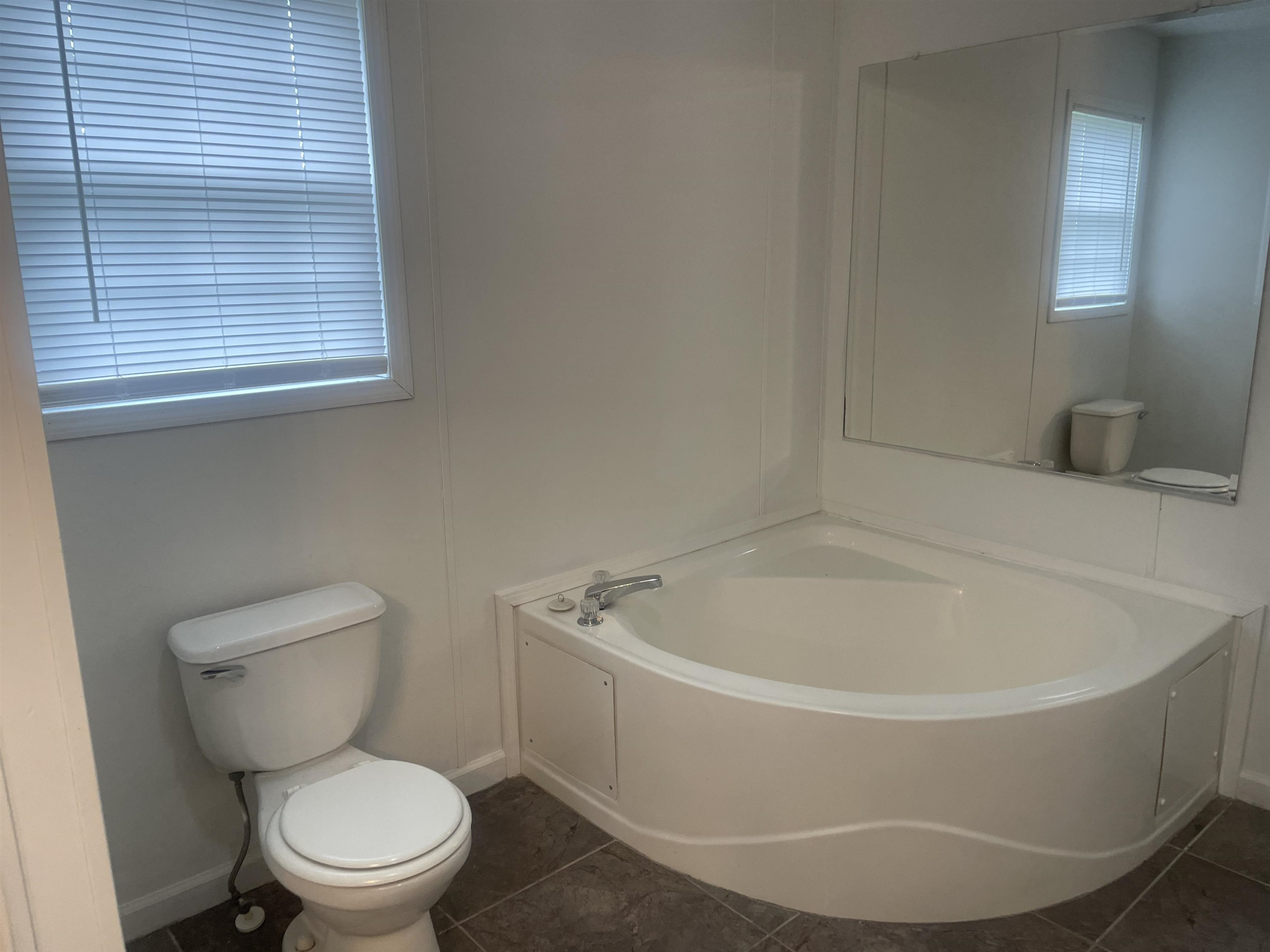 1175 Lott Road Henderson, TN 38340 - Photo 9 of 22 a white bath tub sitting next to a toilet