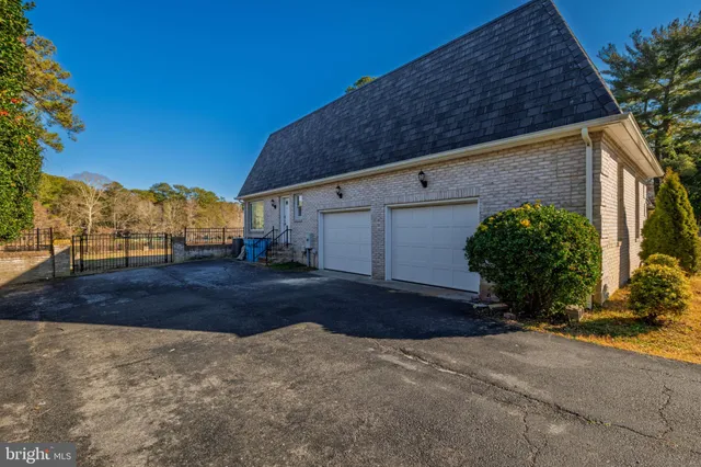 a view of a pathway with a wrought fence