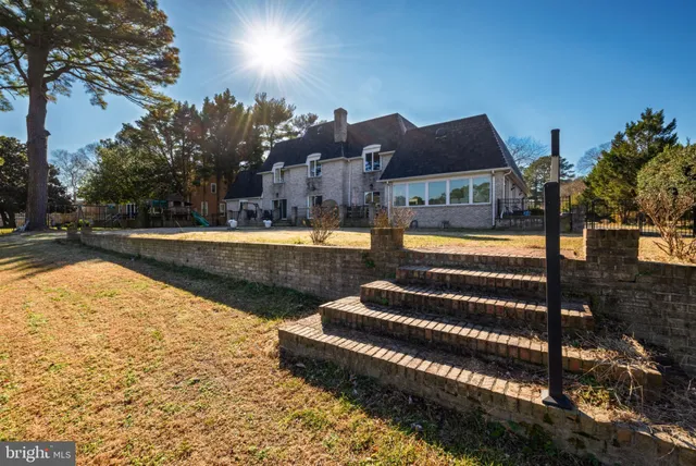 a large kitchen with stainless steel appliances a sink and cabinets