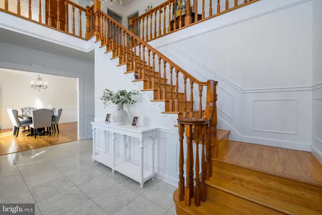 a dining room with furniture a chandelier and wooden floor