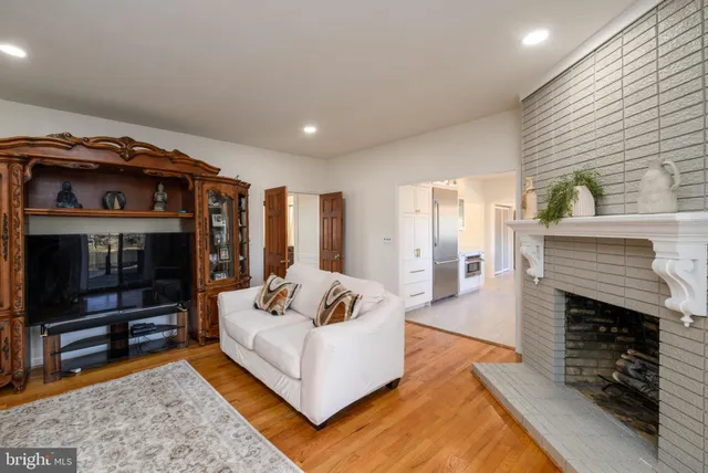 a living room with fireplace furniture and a wooden floor