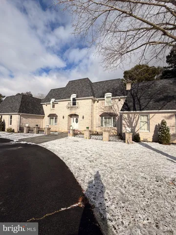 a view of a house with snow on the background