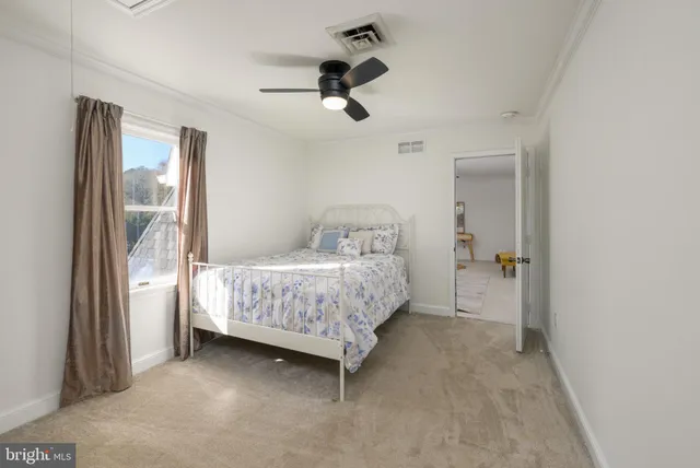 a bathroom with a toilet sink double vanity and mirror