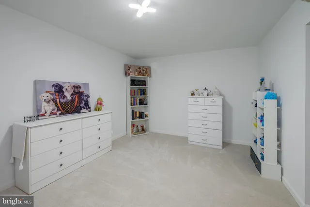 a bed room with a bed mirror and a night stand