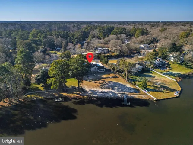 a aerial view of a house with a yard and garden in the back