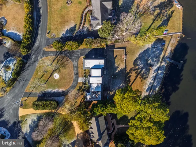 a view of swimming pool with lawn chairs and plants