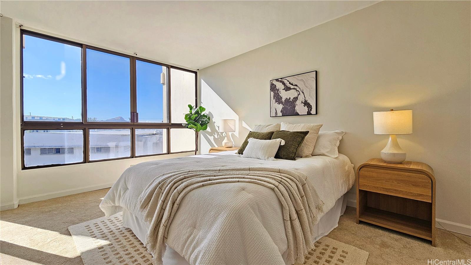 a bedroom with a large bed and a large window