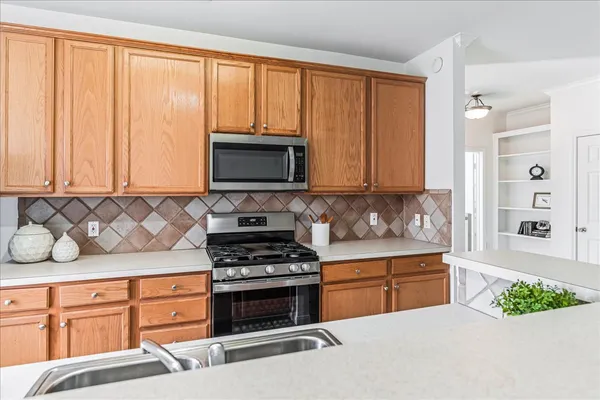 a kitchen that has a sink and a stove