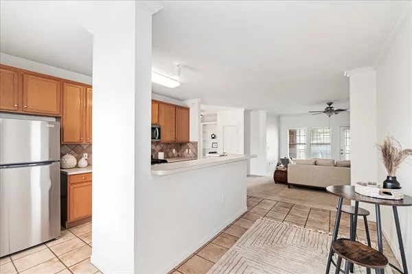 a kitchen with granite countertop a stove top oven a sink dishwasher and a refrigerator with wooden floor