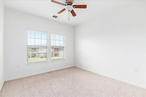 a view of walk in closet with empty racks