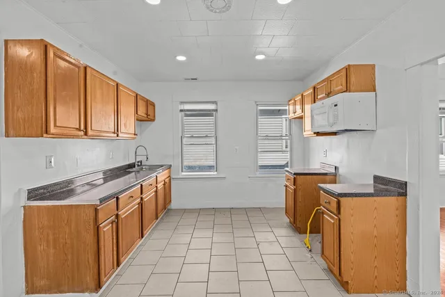 a kitchen with stainless steel appliances granite countertop a sink and cabinets