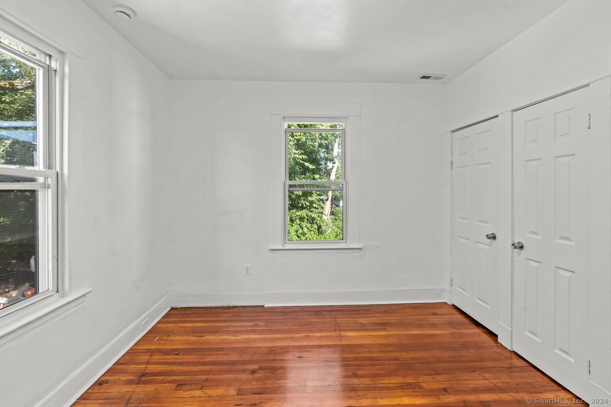 56 Blake Street, Unit 2 New Haven, CT 06511 - Photo 13 of 16 a view of an empty room with wooden floor and a window