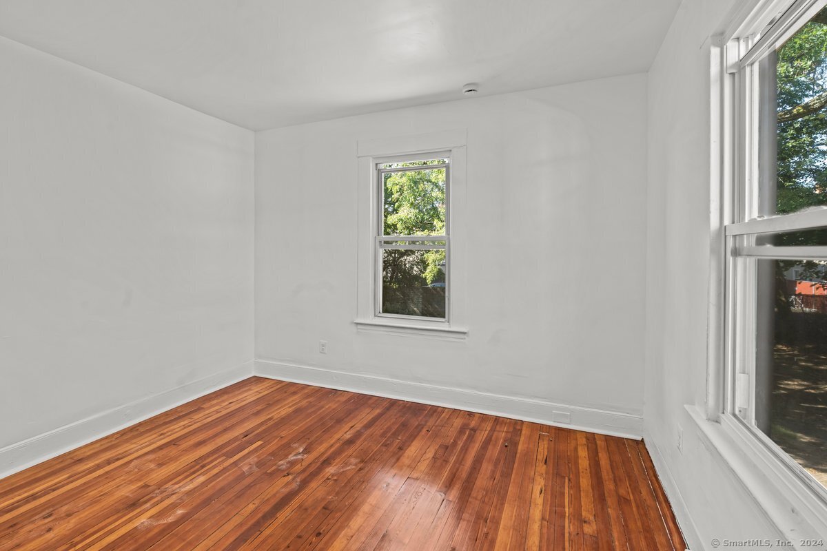 56 Blake Street, Unit 2 New Haven, CT 06511 - Photo 15 of 16 wooden floor in an empty room with a window
