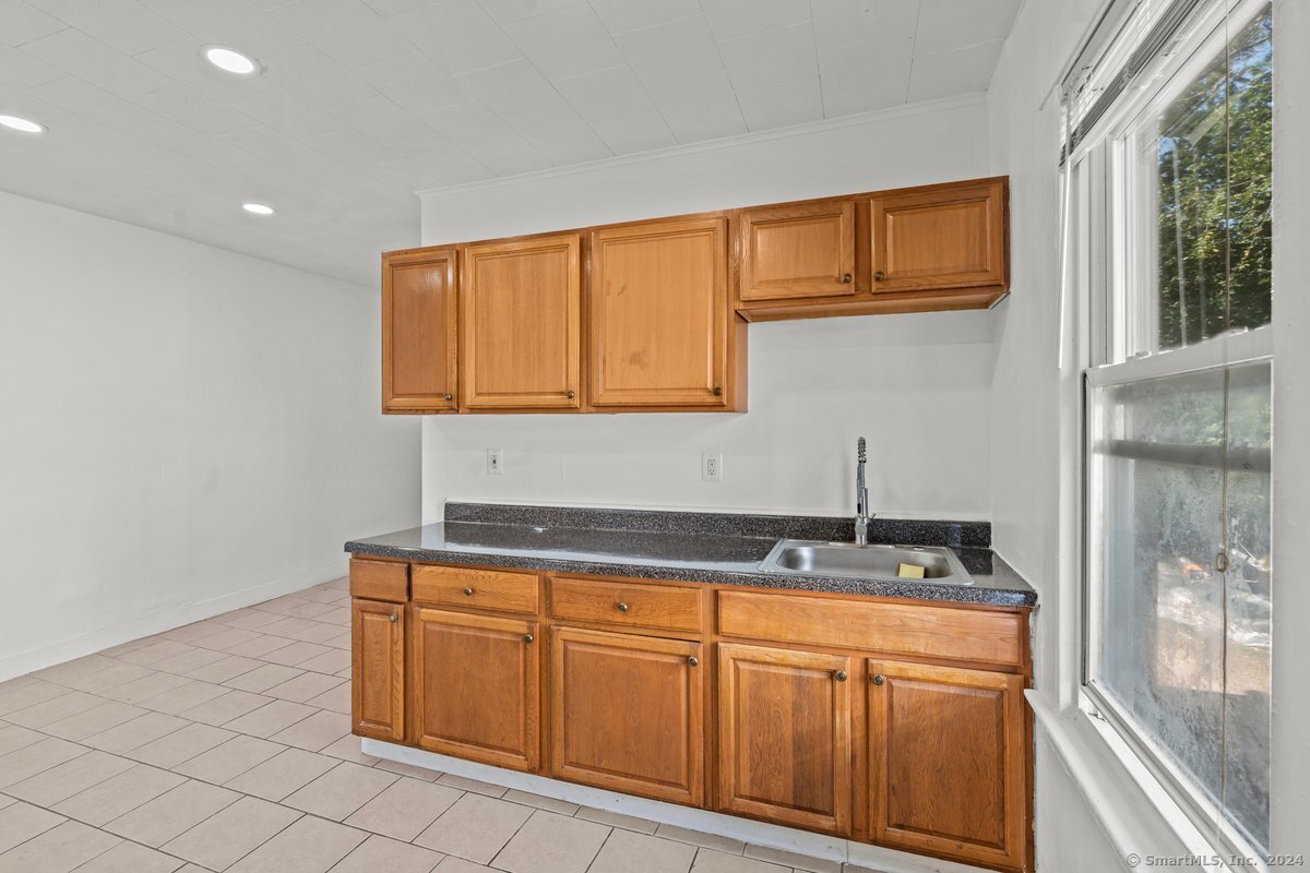 56 Blake Street, Unit 2 New Haven, CT 06511 - Photo 3 of 16 a kitchen with stainless steel appliances granite countertop a sink and cabinets