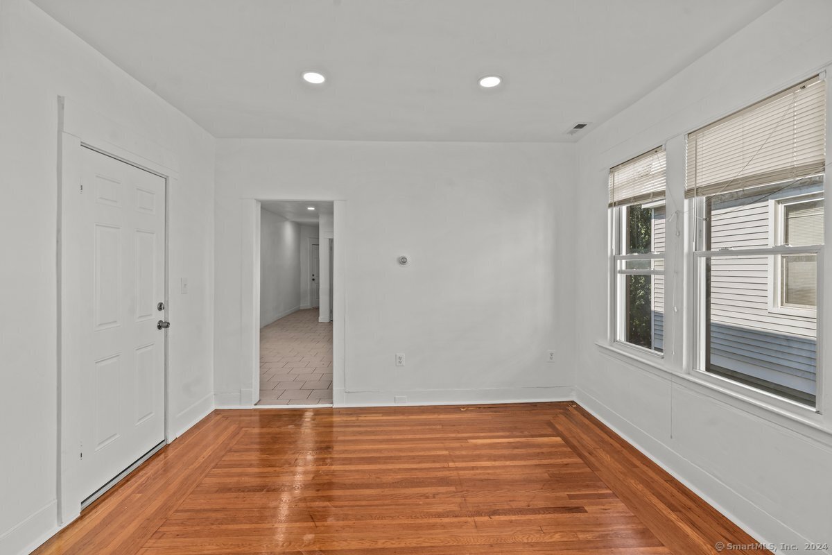 56 Blake Street, Unit 2 New Haven, CT 06511 - Photo 8 of 16 a view of an empty room with wooden floor and a window