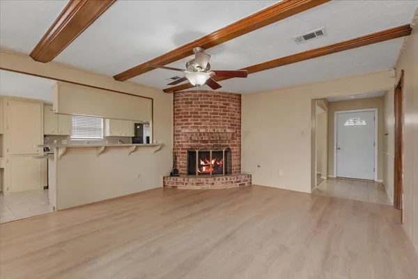 a view of a livingroom with a fireplace and window