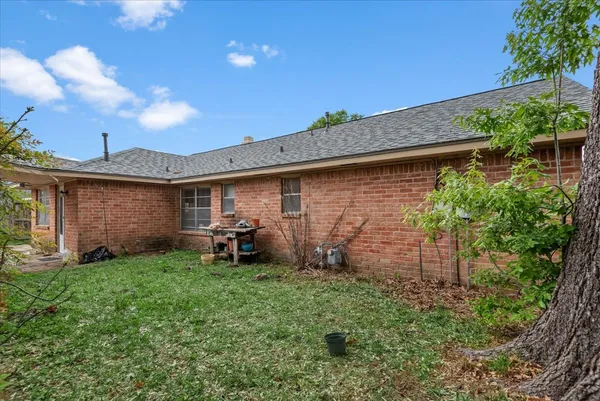 a backyard of a house with table and chairs